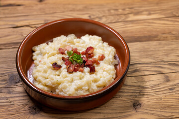 Slovakian halusky served with sheep cheese and roasted bacon