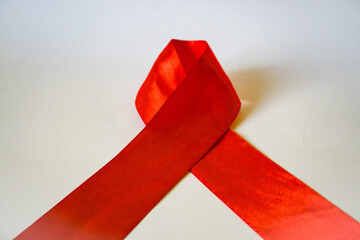 Close up focus on red ribbon on white background, annual regular health check up