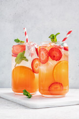 Orange cocktail with strawberries, summer drink