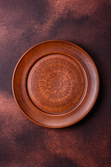 Empty ceramic round plate on dark textured concrete background