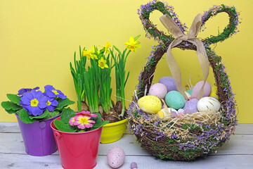 easter eggs in a basket with flowers