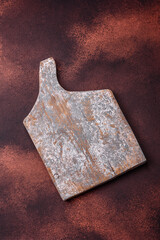 Empty rectangular wooden cutting board on textured concrete background