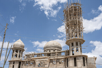 A new mosque under construction, building a new grand Masjid mosque in Ethiopia, with a big dome and high minaret, wooden scaffolds.