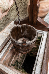 Vintage wooden well bucket and stone well for water usage in Meteora Monasteries, Greece
