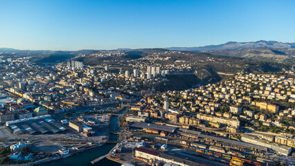 Fototapeta premium Breathtaking aerial view of Rijeka, Croatia, as a ship is being unloaded in the bustling port 