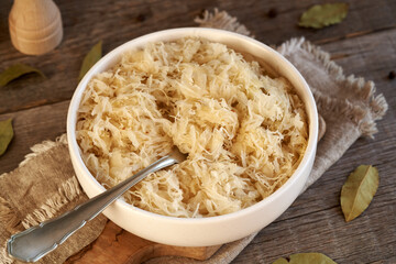 Fermented cabbage or sauerkraut in a bowl with a fork