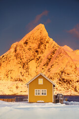 Lofoten islands beautiful nature sunset landscape in Norway and fishing town with scenic yellow rorbu house of Sakrisoy, Reine - 740283151