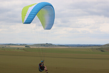 Paraglider flying from a hill	