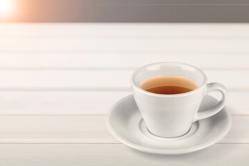 Tasty hot tea in cup on the desk