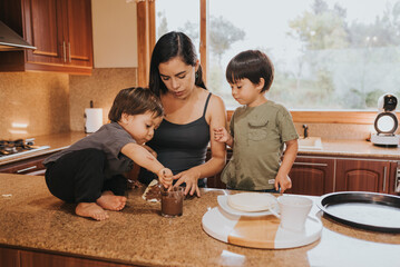 Mother cooking with her boys