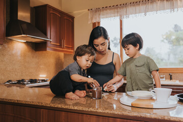 Mother cooking a dessert with her sons