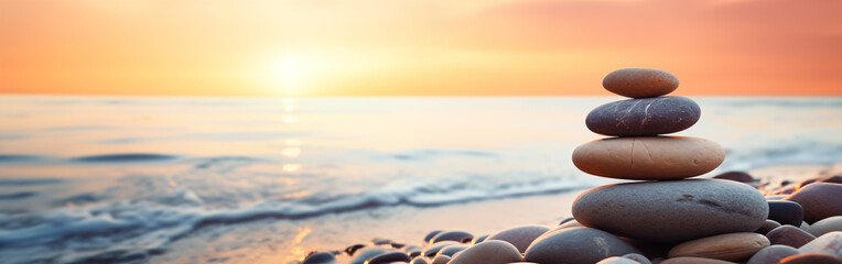balance zen stones at the beach at sunrise