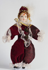 Porcelain Italian doll depicting the hero of the Commedia Del Arte in a red suit. - 740299990