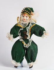Porcelain Italian doll depicting the hero of the Commedia Del Arte in a green suit. - 740302180