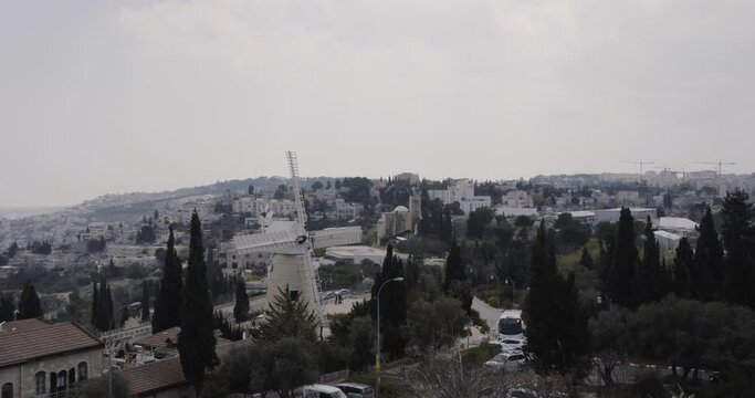 Aerial Footage of the Montefiore Windmill which was built in 1858 in the Mishkenot Sha'ananim neighborhood in Jerusalem. In the background are the walls of the Old City and the Tower of David.