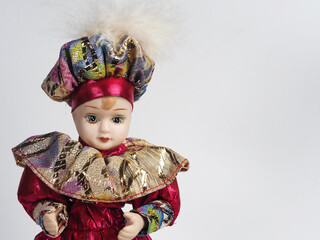 Sweet Porcelain Italian doll depicting the young hero of the Commedia Del Arte in a red suit with golden frills and a hat. - 740302972