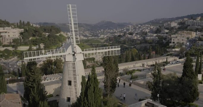 Aerial Footage of the Montefiore Windmill which was built in 1858 in the Mishkenot Sha'ananim neighborhood in Jerusalem. In the background are the walls of the Old City and the Tower of David.