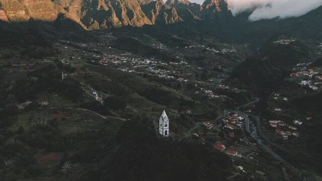 Drone flight at Nossa Senhora de Fatima Chapel, Madeira with the Chapel in view and a tilt up and pan to the right towards the mountains in the background