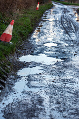 A road in Sussex with mutiple pot holes