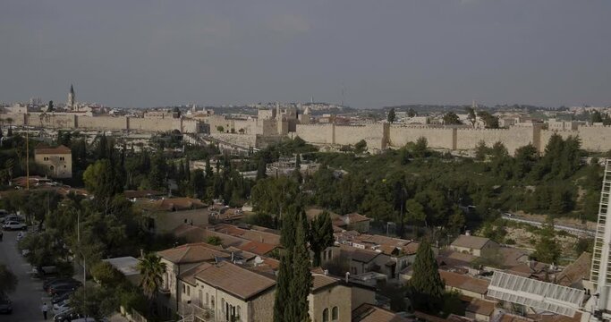 Aerial Footage of the Montefiore Windmill which was built in 1858 in the Mishkenot Sha'ananim neighborhood in Jerusalem. In the background are the walls of the Old City and the Tower of David.
