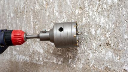 Installation of sockets in the house. A hammer drill with a drill for drilling electrical sockets....