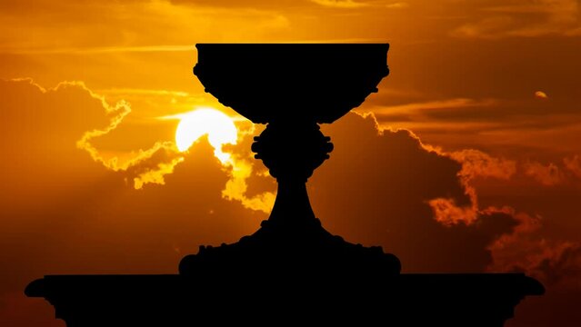Holy Grail cup or Sacred graal: Time Lapse at Sunset with Red Sun and Fiery Sky