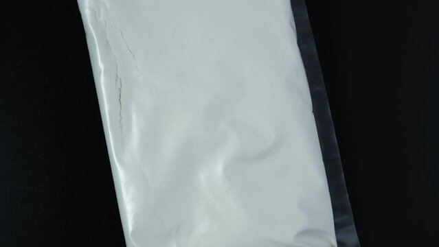 Carboxymethylcellulose (CMC), carmellose, or croscarmellose powder in plastic bag. 4K Video, Rotating. Sodium Carboxymethyl Cellulose. Food additive E466 used in food and non-food applications.