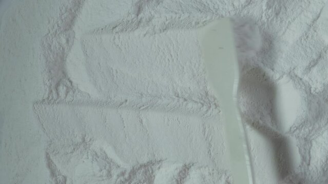 Texture of Carboxymethylcellulose, or carmellose, or croscarmellose powder, close-up. 4K Video. Food additive E466. CMC, effective water binders for use in food and non-food applications.