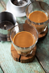 Vietnamese coffee in glass cups on old boards, open phin filter