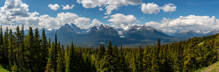 Wilderness views in Banff National Park during summer time with snow capped mountains on a blue...