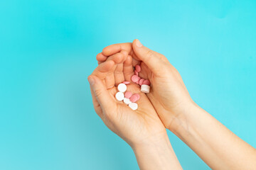 Pills and medicines on the palms. The woman is holding pills in her hands. 