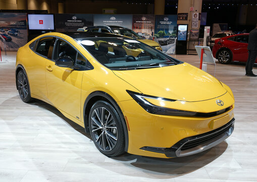 TORONTO-FEBRUARY 15, 2024: Toyota Prius Limited AWD Maximum Yellow new car model at the 2024 Canadian International Auto Show in Toronto