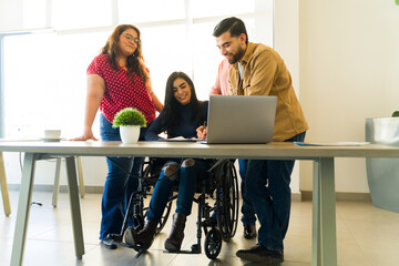 Full length of a Latin woman on a wheelchair reviewing a contract in a meeting room