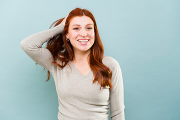 Cheerful woman with beautiful long red hair smiling