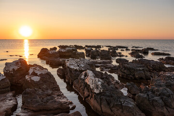 Rocks on sea in sunset