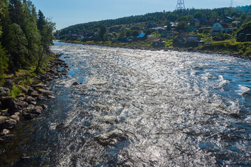 rapids on the Umba river, Kola peninsula, Russia, against the background of a forest