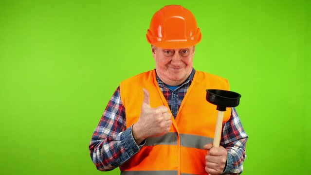 Senior smiling plumber in uniform shows his tool plunger, choose me, I best.