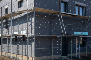 modern thermal insulation materials. building New House in process insulation of the wall of the...
