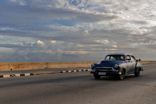 Old dark blue-white almendron car -yank tank, Chevrolet American classic- from 1951 on El Malecón esplanade, El Vedado neighbourhood. Havana-Cuba-006