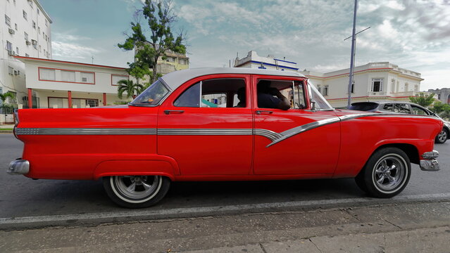 Old red painted almendron car -yank tank, Ford American classic- from 1956 on Linea street, El Vedado neighbourhood. Havana-Cuba-013