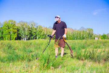 treasure hunter in the field looking for old coins and artifacts
