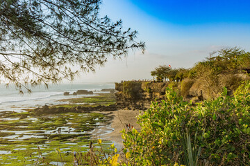 Bali, Indonesia - Oct 14, 2015: Tanah Lot Temple, located on the water at low tide.