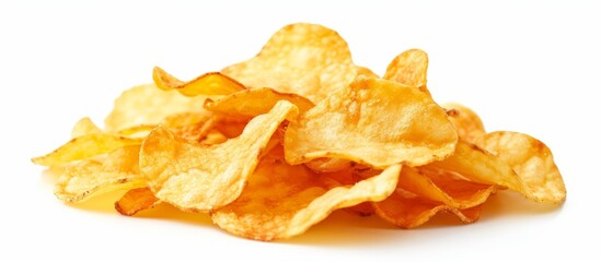 A pile of potato chips, a popular junk food, sits on a white background. These fried finger foods...