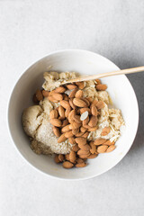 overhead view of almond biscotti dough in a white bowl, almond cantucci cookie dough in ceramic mixing bowl, flatlay of biscotti cookie dough or twice baked cookies