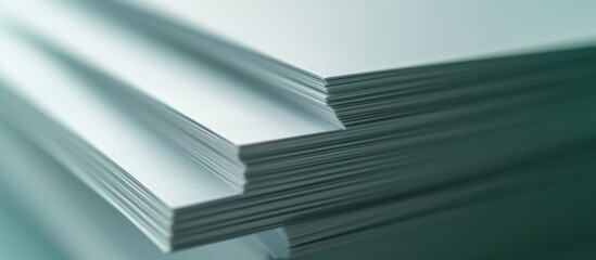 A close up of a stack of paper sheets on top of each other, made of composite material. The stack...