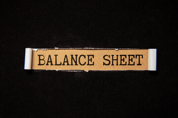 Balance Sheet. text on an open notebook on an envelope with money.