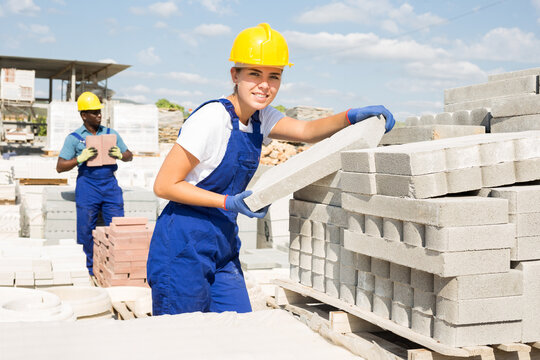 Attractive female sellerman is calculating redbricks before selling in construction store