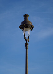 Parisian street lamp on blue sky background in Concorde Square 