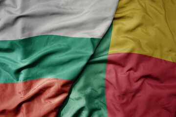 big waving national colorful flag of benin and national flag of bulgaria .
