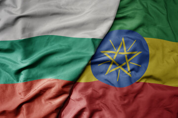 big waving national colorful flag of ethiopia and national flag of bulgaria .